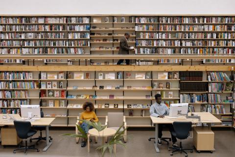 Decorative people at workstations in library